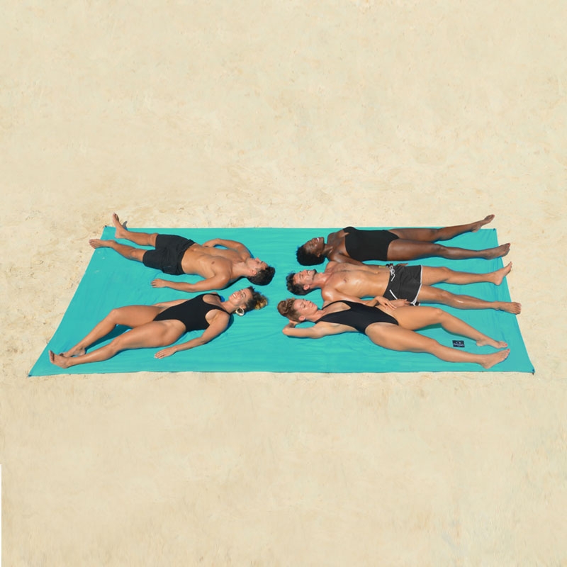 Drap de plage LE BIG Moorea Turquoise d'Ôbaba - cinq personnes allongées sur le sable